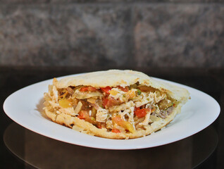 Arepa stuffed with shredded chicken with tomatoes and sauce to taste 2