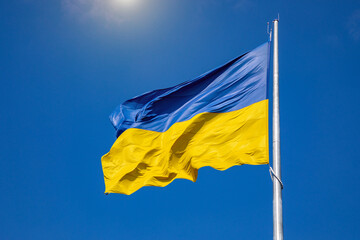Flag of Ukraine on a background of blue sky. The largest flag in Ukraine.
