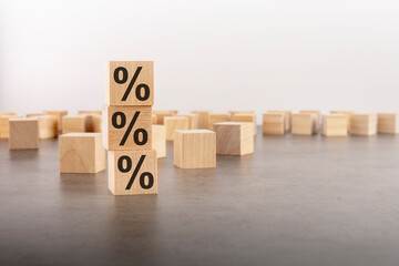 three wooden cubes with percent signs. concept of financial and mortgage interest rate. with copy space.