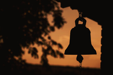 ancient bell silhouette in church , place of relaxation and worship, sunrise religion concept - obrazy, fototapety, plakaty