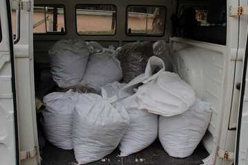 White raffia bags containing agricultural inputs for the garden, stored and arranged in the body of...