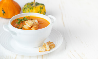 Pumpkin soup with croutons on white background. Copy space