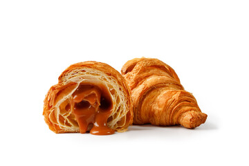 Fresh baked Croissant with liquid caramel inside isolated on white background. Delicious french...