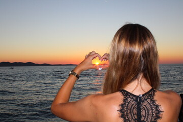 girl on the beach at sunset love heart