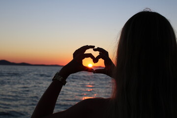 girl on the beach at sunset love heart