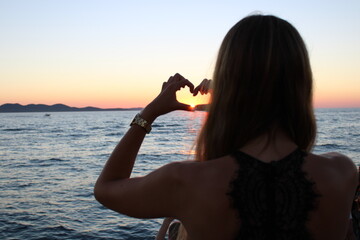 girl on the beach at sunset love heart
