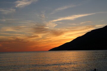 Sunset at the beach with mountain