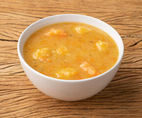 Vegetable soup in a bowl over wooden table