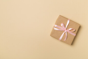 Craft gift box on color background, top view