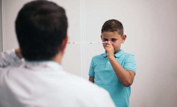 An ophthalmologist used a brock cord to maintain vision in a child's eyes. Eye vision therapy.