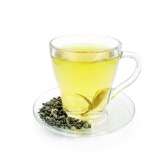 Green tea in glass cup on transparent saucer with scattering dry tea leaves isolated on white background  