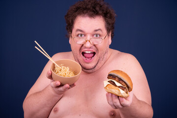 Sport, fitness and healthy lifestyle. Funny fat guy goes in for sports and eats a hamburger.	