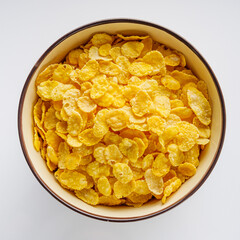 crispy golden cornflakes on a white acrylic background