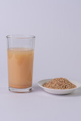 Small beans bowl and small beans drink on a glass, on a white table