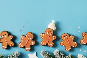 Row gingerbrads men on stick on blue background