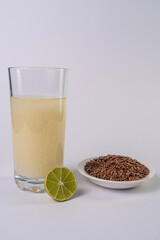 Linseed bowl and linseed drink on a glass, on a white table