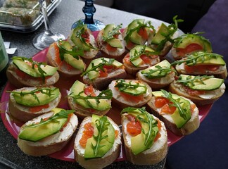 Bruschetta with avocado, ruccola, salmon and cheese