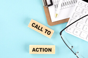 CALL TO ACTION text written on wooden block with clipboard,eye glasses and calculator Business concept.