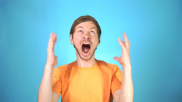 Portrait of angry furious man screaming with anger closing his eyes in despair having unhappy expression.