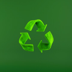 Lush green grass recycling symbol on green background.