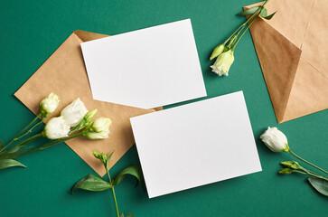 Blank invitation card mockup with envelope and flowers, front and back sides