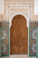 Old Arabian style gate entrance with a wooden closed door in Marrakesh landmark