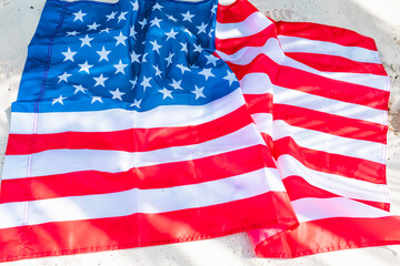 American flag on beach near ocean sea shore, concept of celebrating America's USA Independence Day on July 4 and patriotic education