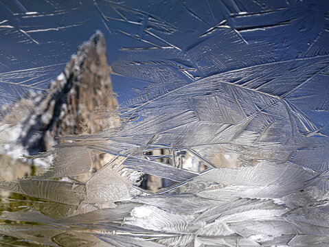 Reflection of the famous Clyde Minaret in an icy lake, California, USA