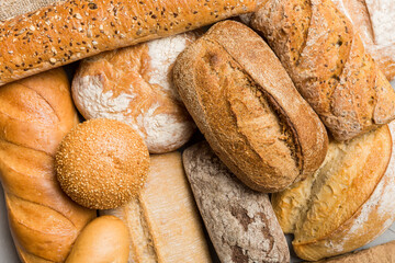 Homemade natural breads. Different kinds of fresh bread as background, top view with copy space