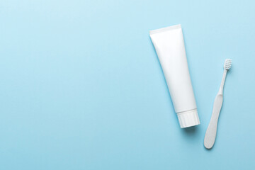 toothpaste and toothbrush top view with copy space on colored background. Flat lay. Dental hygiene. Oral care products on light background. Body care concept