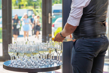 Waiter serving champagne to the guests