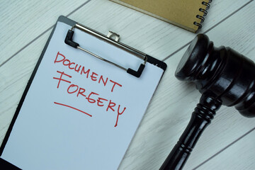 Concept of Document Forgery write on a paperwork with gavel isolated on Wooden Table. - obrazy, fototapety, plakaty