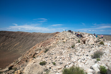 Visitors Exploring The Barringer Meteor Crater where a Meteor Blasted a Giant Hole in the Desert