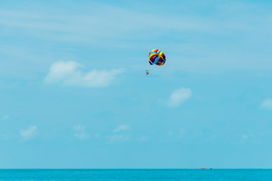 Rainbow parachute on the background of the blue sea and sky. Landscape. Summer. Vacation.