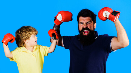 Little boxer champion and coach in boxing gloves. Ready for sparring. Child sportsman at training.