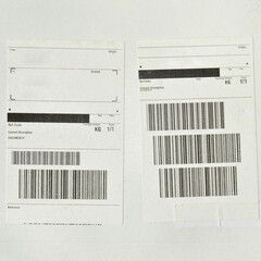 White cardboard paper mail envelope on sticky barcodes