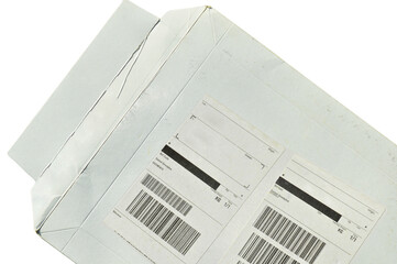 White cardboard paper mail envelope on sticky barcodes