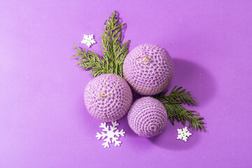 Crocheted Christmas balls and festive New Year decor in a fashion lilac very peri color