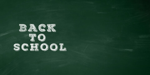 Green chalkboard with abstract texture of chalk and text back to school text