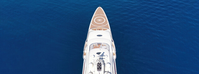 Aerial drone top down ultra wide photo with copy space of luxury mega yacht with wooden deck and...