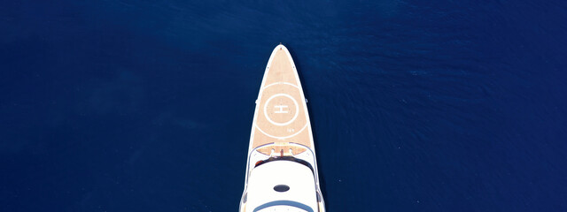 Aerial drone top down ultra wide photo with copy space of luxury mega yacht with wooden deck and...
