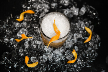 Fototapeta na wymiar Alcoholic cocktail with beer, ice and lemon juice, bar tools. Low key, selective focus