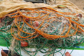 Fishing nets with floats lie on the boat. Close-up 