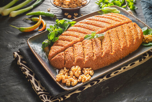 Arabic Cuisine;  Traditional Middle eastern dish "Kibbeh Nayyeh" or "Raw Kibbeh". It is a famous Levantine mezze of bulgur wheat and spices. It served with mint leaves ,green onion and olive oil.