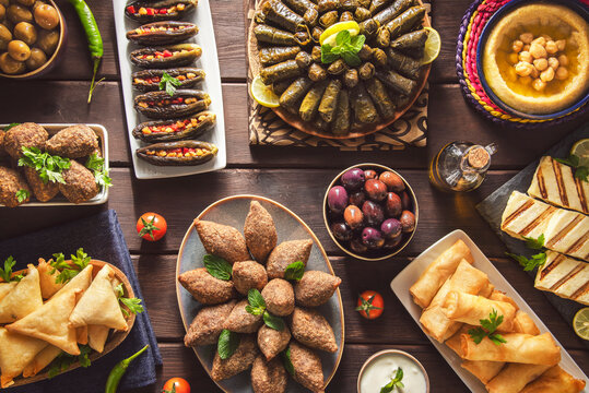 Arabic Cuisine;  Middle Eastern traditional dishes and assorted mezze or meze. Vine leaves, kibbeh, spring rolls, sambusak, kibbeh nayyeh, makdous, haloumi cheese, olives, hummus and yogurt salad.