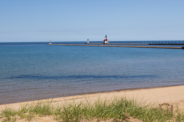 Sand beach and beachgrass with St. Joseph North Pier Inner Lighthouse and St. Joseph North Pierhead...