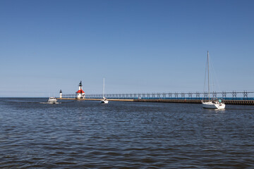 Boats in the channel and St. Joseph North Pier Inner Lighthouse and St. Joseph North Pierhead Outer...