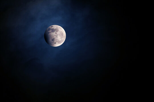 Shining moon on a dark background. Elements of this image furnished by NASA