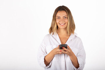 Young businesswoman portrait with smartphone in studio.