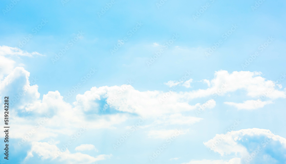Wall mural a vast light blue sky with freedom shape of fluffy clouds floating over the air. soft and pure cloud